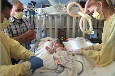 Hussein El Kerdi during his 2016 procedure at UCLA. His father, Ali El Kerdi (with cell phone) looks on.