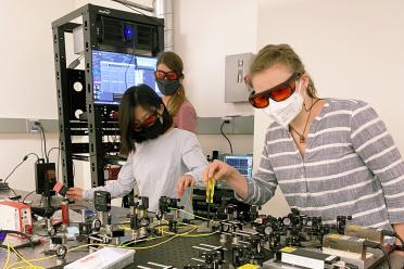 Ph.D. students Brittany Lu, post-doc Ana Valdes-Curiel and Ph.D student Vanessa Scheller collaborate in the Quantum Biology Tech lab led by Clarice Aiello