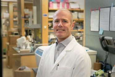 Headshot of S. Thomas Carmichael in a lab wearing a lab coat