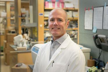 Headshot of S. Thomas Carmichael in a lab coat