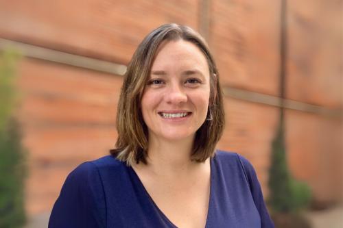 A woman smiles into the camera.