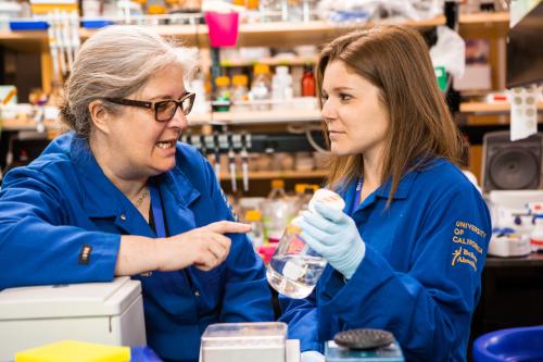 UCLA scientist samantha butler talks to a student in the lab