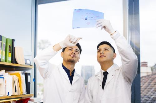 Two UCLA researchers study a document.