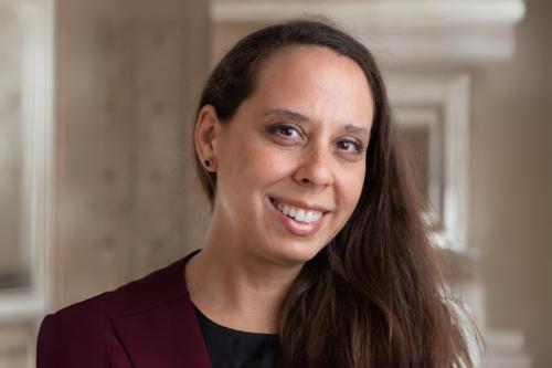 A woman smiles into the camera.