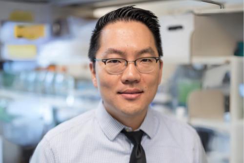 A man in a UCLA lab smiles into the camera.