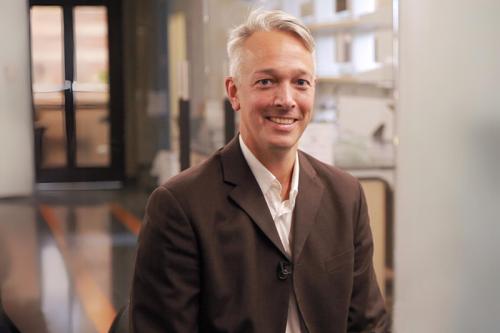 Researcher Alexander Hoffman smiles for a photograph.