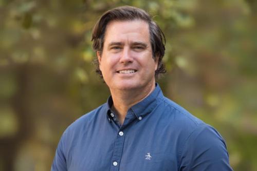 Researcher Jeff Long smiles for a photo outdoors.