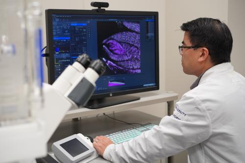 Man sitting at microscope