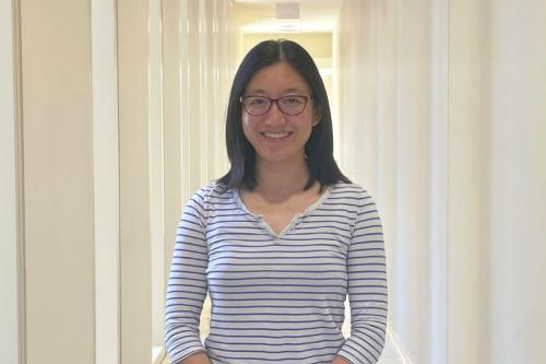 Ye Zhang smiles in a UCLA hallway.