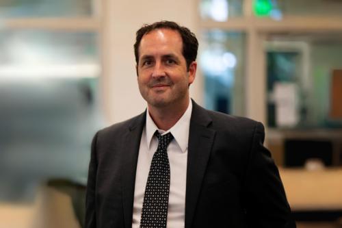 Researcher Robert Prins smiles in a suit 