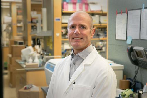 Headshot of S. Thomas Carmichael in a lab wearing a lab coat