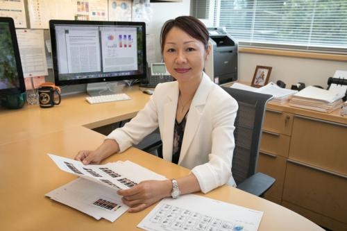 Lily Yang smiles in her office. 