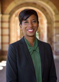 Dean Tracy Johnson stands smiling for a photograph. 