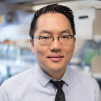 A man in a UCLA lab smiles into the camera.