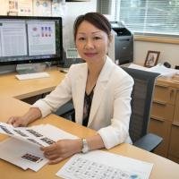 Lily Yang smiles in her office. 